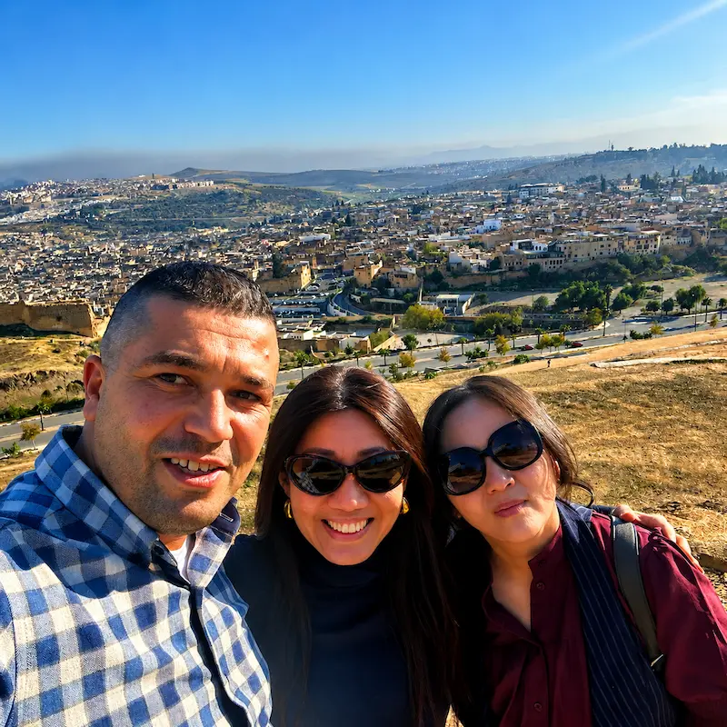 Private driver with two travellers at a viewpoint over the Fes medina at the end of the transfer from Tangier